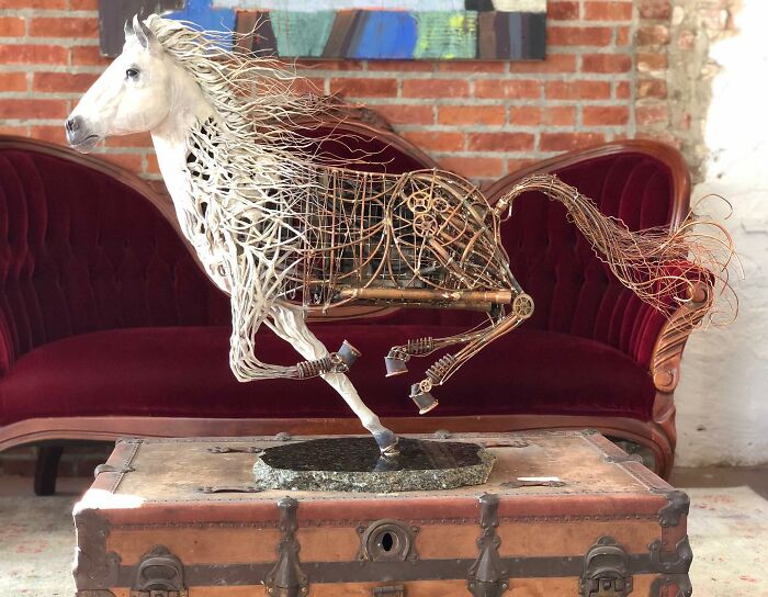 Horse sculpture made from scrap metal by artist, showcasing striking animal sculptures with detailed wire and gear design.