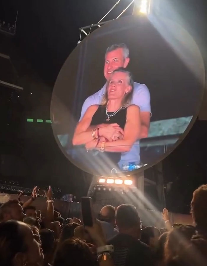 Couple embracing on stage during concert, reflecting Coldplay frontman viral drama and Gwyneth Paltrow support. Couple embracing on stage during concert, reflecting Coldplay frontman viral drama and Gwyneth Paltrow support.