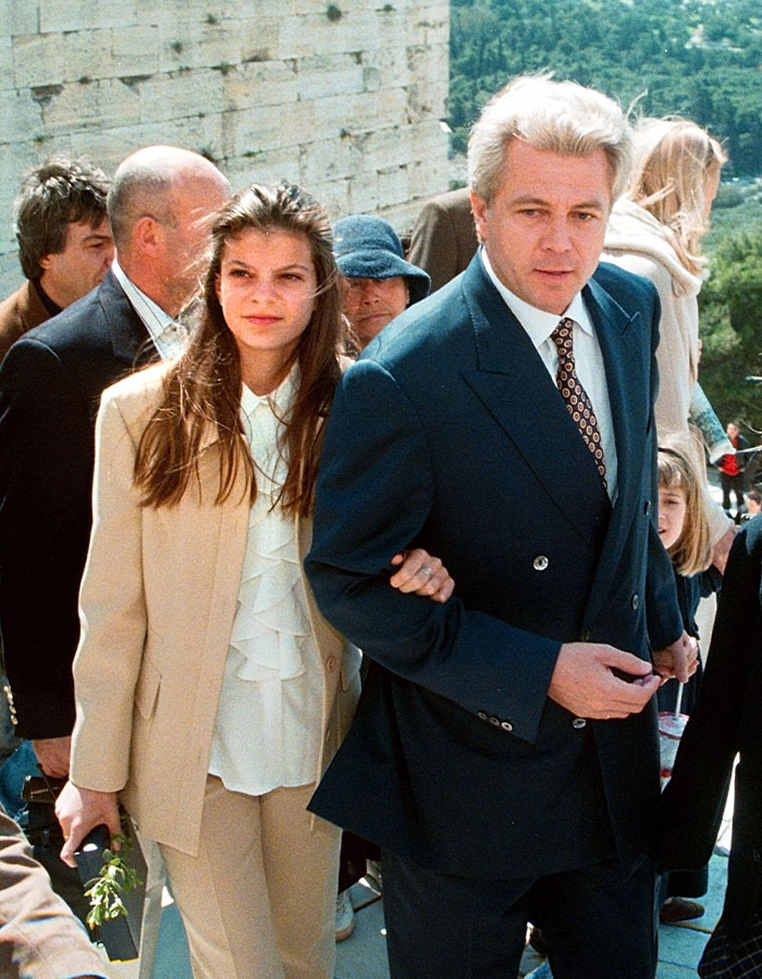 Athina Onassis, reclusive billionaire, pictured in a beige suit walking arm in arm during a rare public appearance. Athina Onassis, reclusive billionaire, pictured in a beige suit walking arm in arm during a rare public appearance.