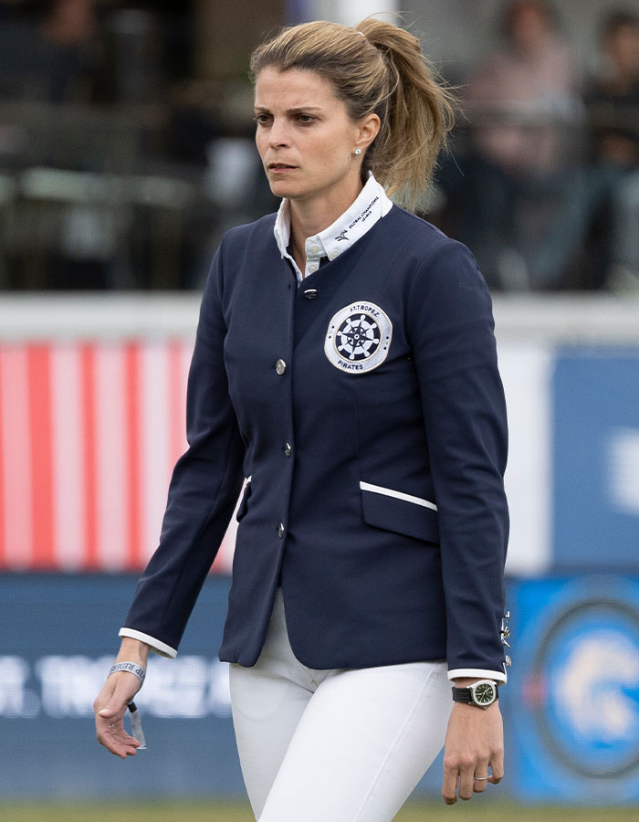 Athina Onassis wearing a navy blazer and white pants, making a rare appearance in a sports event after years in seclusion Athina Onassis wearing a navy blazer and white pants, making a rare appearance in a sports event after years in seclusion