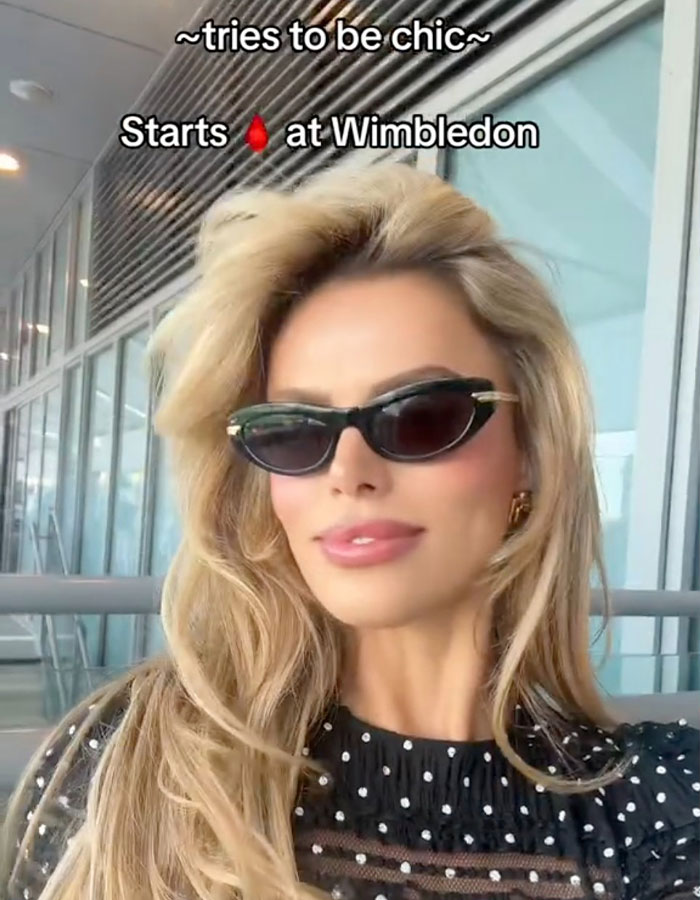 Brooks Nader wearing sunglasses and a black polka dot top, praised for normalizing period leaks and women’s health. Brooks Nader wearing sunglasses and a black polka dot top, praised for normalizing period leaks and women’s health.