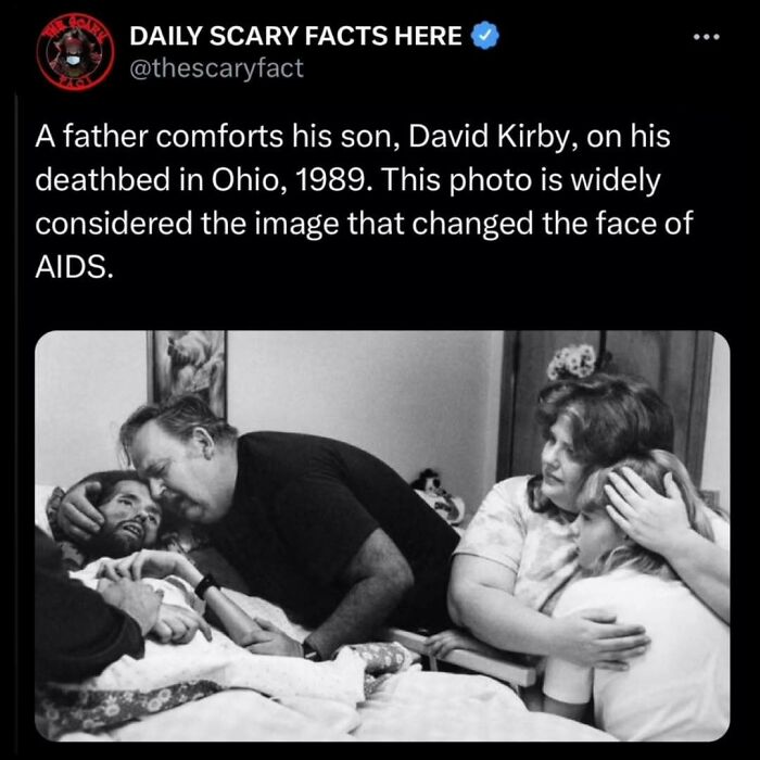 Black and white photo showing a father comforting his son on his deathbed, illustrating a scary fact about AIDS impact. Black and white photo showing a father comforting his son on his deathbed, illustrating a scary fact about AIDS impact.