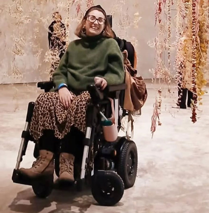 Woman in a wheelchair wearing glasses and leopard print skirt, symbolizing mom struggles and protecting kids from breathing issues. Woman in a wheelchair wearing glasses and leopard print skirt, symbolizing mom struggles and protecting kids from breathing issues.