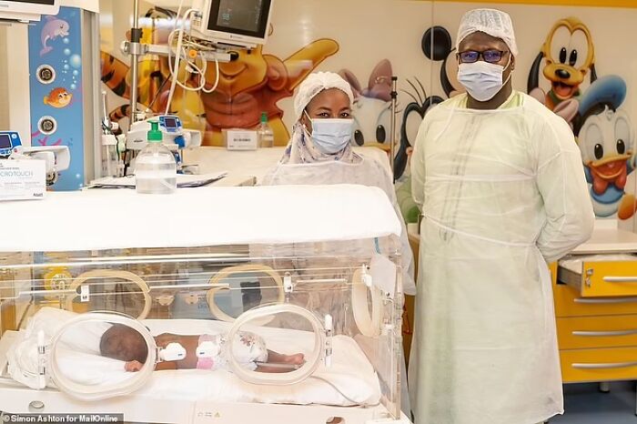 Medical staff in protective gear attending to the world’s first surviving nonuplets in a hospital nursery. Medical staff in protective gear attending to the world’s first surviving nonuplets in a hospital nursery.