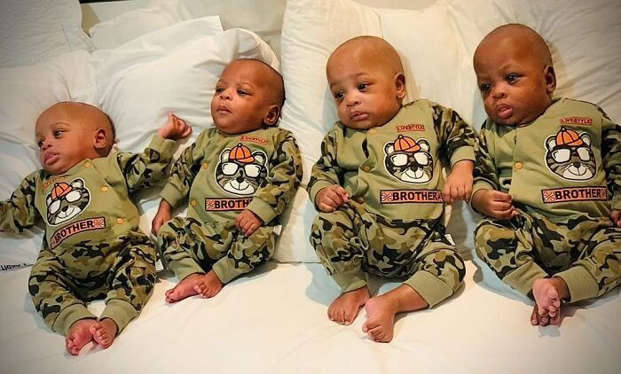 Four of the world’s first surviving nonuplets wearing matching camo outfits, lying on a bed and growing up fast Four of the world’s first surviving nonuplets wearing matching camo outfits, lying on a bed and growing up fast