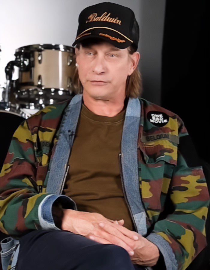 Stephen Baldwin wearing a camo jacket and Baldwin cap, reacting to Hailey Bieber’s $1B Rhode sale amid family rift. Stephen Baldwin wearing a camo jacket and Baldwin cap, reacting to Hailey Bieber’s $1B Rhode sale amid family rift.