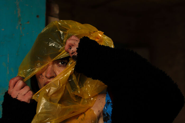 Antonia Breathes Through Layers Of Translucent Plastic, An Ironic Veil