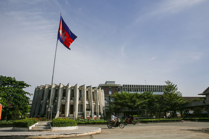 Modern cityscape with government buildings and a national flag, representing smartest countries shaping the future.