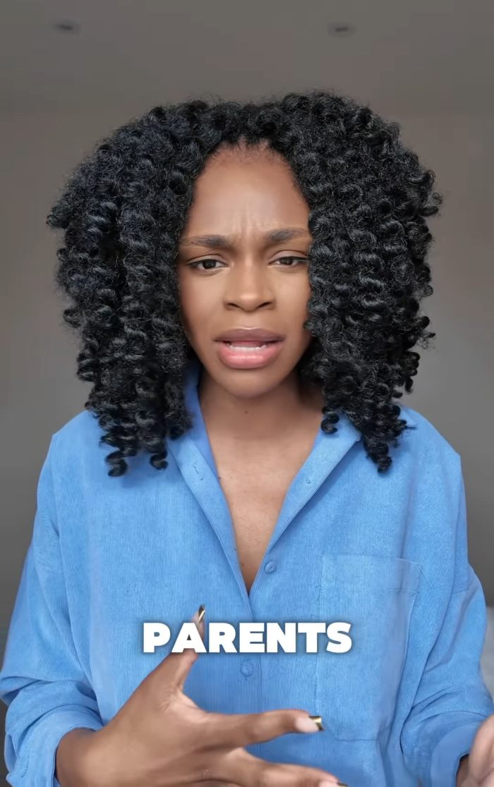 African American woman in blue shirt expressing concern about parenting topics in a casual indoor setting. African American woman in blue shirt expressing concern about parenting topics in a casual indoor setting.
