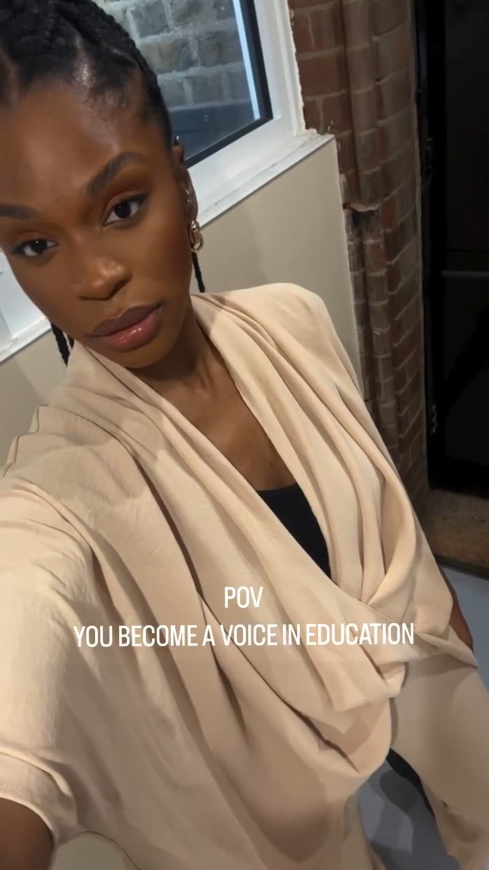 African American woman wearing beige clothing, standing indoors near a window, representing toddler realizing she’s Black. African American woman wearing beige clothing, standing indoors near a window, representing toddler realizing she’s Black.