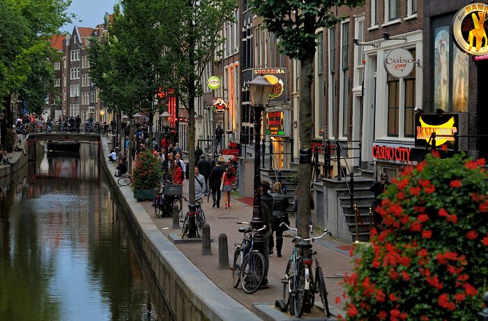 Busy urban canal scene in one of the smartest countries shaping the future with lively streets, bicycles, and historic buildings.