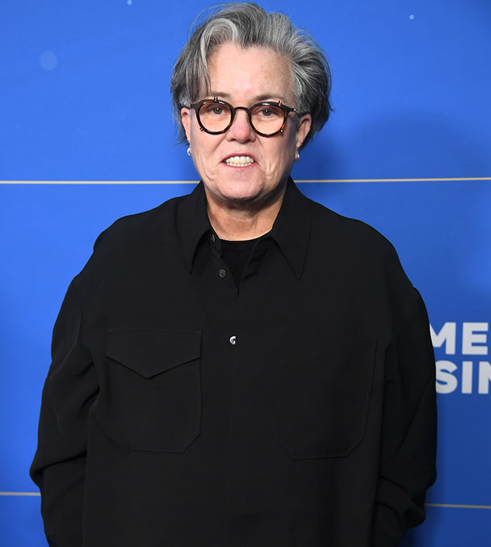 Comedian Rosie O'Donnell wearing glasses and a black shirt at an event about celebrities criticizing Jeff Bezos and Lauren Sánchez wedding.
