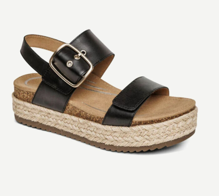 Black platform sandal with buckle strap and woven sole, a stylish comfortable pick for sandal season in Europe.