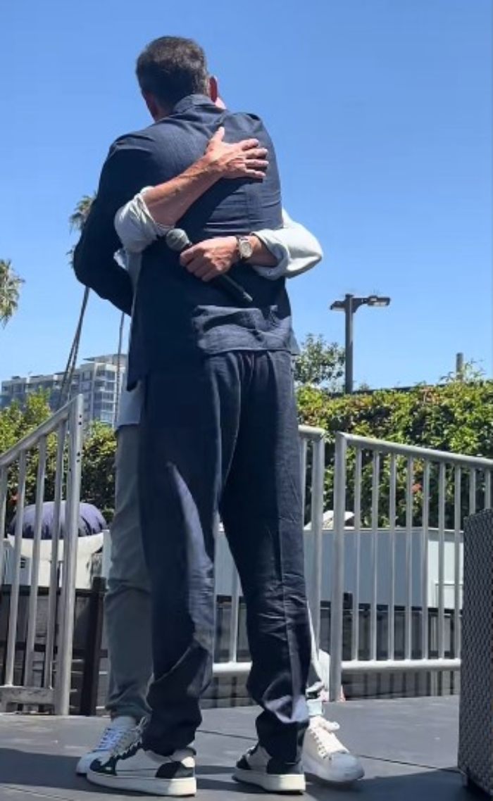 Two Harry Potter stars hugging warmly outdoors during a surprise reunion that excites fans under a clear blue sky. Two Harry Potter stars hugging warmly outdoors during a surprise reunion that excites fans under a clear blue sky.