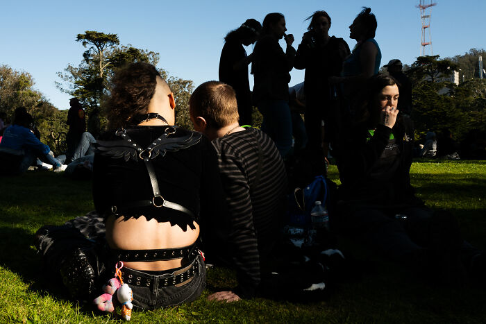 Group of people outdoors captured in a candid moment by a photographer snapping coincidental moments in public.