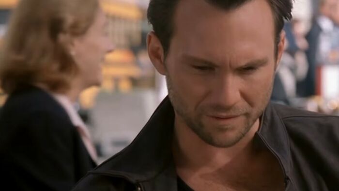 Man in a black jacket with a serious expression in a scene from one of the worst movies of all time.