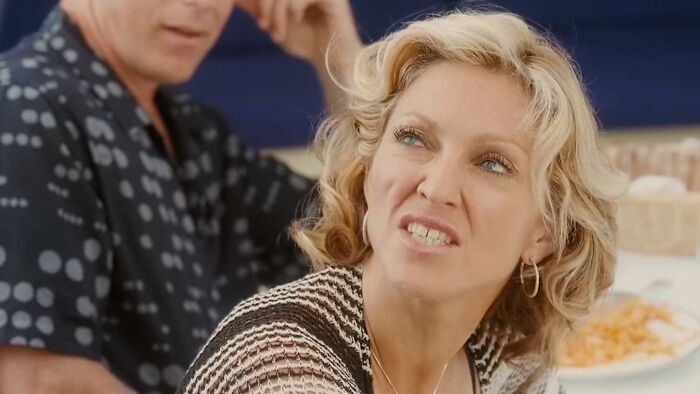 Woman making a disgusted face while sitting at a table, representing worst movies in the hall of shame list.