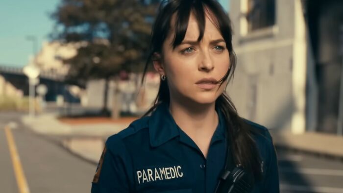 Woman in a paramedic uniform standing outdoors, representing a scene from one of the worst movies of all time.