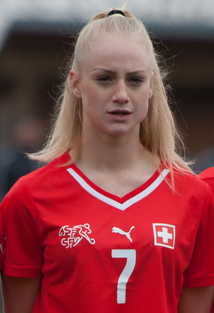 Female footballer wearing red jersey with number 7, representing world's prettiest footballer with stunning transformation. Female footballer wearing red jersey with number 7, representing world's prettiest footballer with stunning transformation.