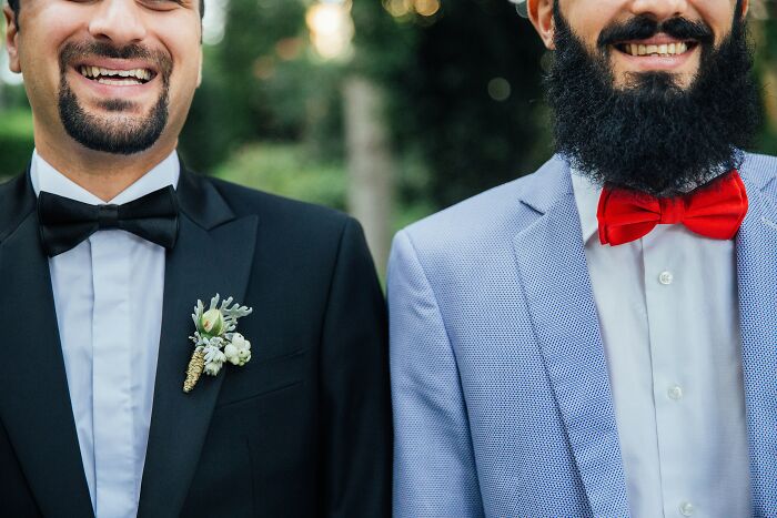 Two men smiling wearing formal suits and bow ties, illustrating outrageous student names shared by a teacher.