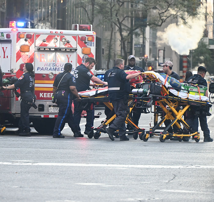 NYPD cop fatally shot, surrounded by emergency responders and paramedics with stretchers near an ambulance on city street. NYPD cop fatally shot, surrounded by emergency responders and paramedics with stretchers near an ambulance on city street.