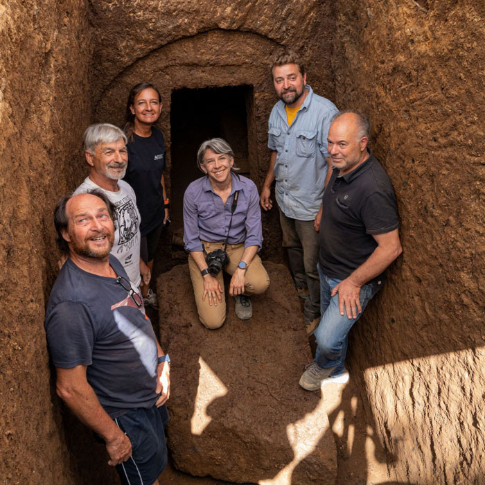 Archaeologists standing inside a 2,600-year-old tomb in Italy near the entrance to a mysterious burial chamber. Archaeologists standing inside a 2,600-year-old tomb in Italy near the entrance to a mysterious burial chamber.