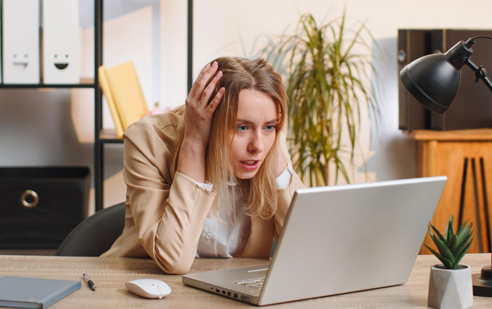 Woman looking stressed at laptop, contemplating asking husband to turn down dream job and career opportunity. Woman looking stressed at laptop, contemplating asking husband to turn down dream job and career opportunity.