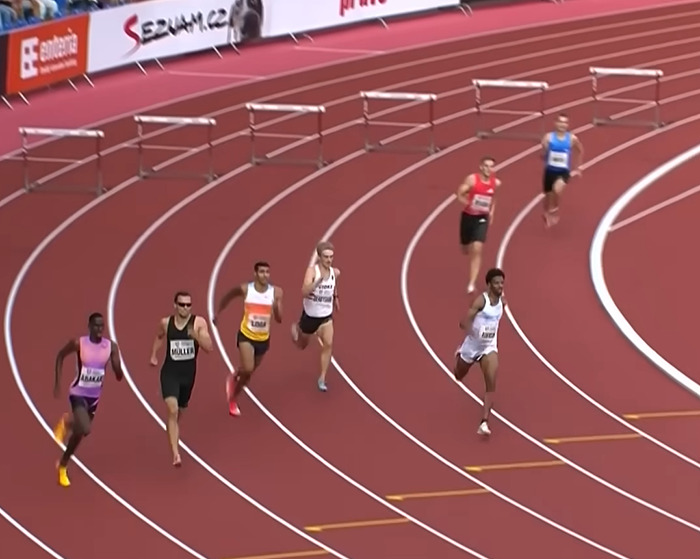 Male sprinters racing on a track during a hurdle event with viral sprinter gaining attention and modeling offers. Male sprinters racing on a track during a hurdle event with viral sprinter gaining attention and modeling offers.