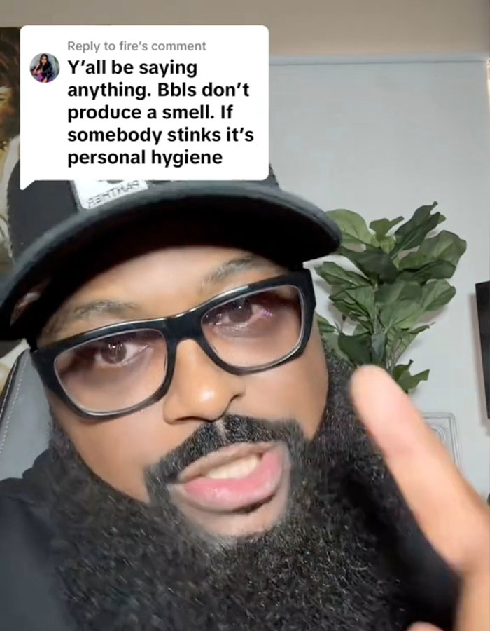 Man with glasses and hat responding to comment about BBL smell and personal hygiene in a casual indoor setting. Man with glasses and hat responding to comment about BBL smell and personal hygiene in a casual indoor setting.