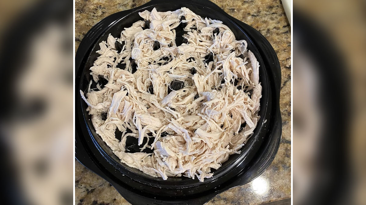 Shredded chicken on a black plate, an example of viral TikTok food trends that took all our money.