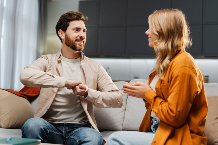 Couple having a tense conversation on couch with lady shocked and husband possibly hiding an affair in a modern living room. Couple having a tense conversation on couch with lady shocked and husband possibly hiding an affair in a modern living room.