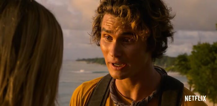 Young man talking to a woman near the beach, representing best Netflix shows that keep viewers coming back for more.