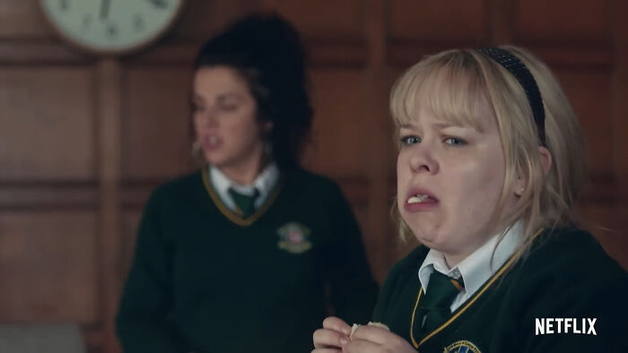 Two young women in school uniforms express emotions in a Netflix show scene popular among best Netflix shows fans.
