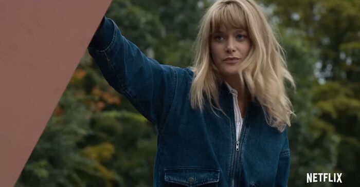 Blonde woman in a denim jacket outdoors, representing popular Netflix shows that keep viewers coming back for more.