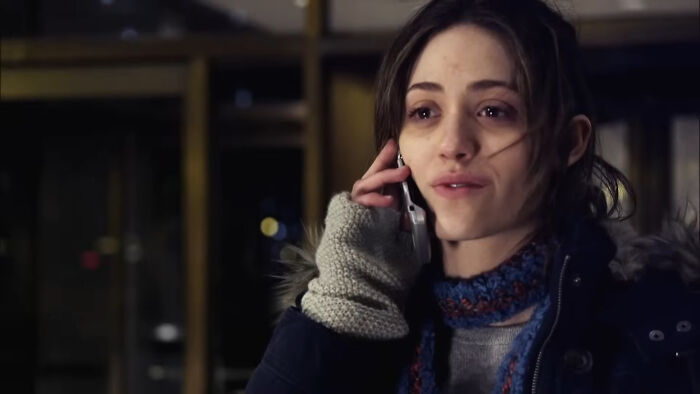 Young woman wearing winter clothes talking on phone, featured in one of the best Netflix shows loved by netizens.