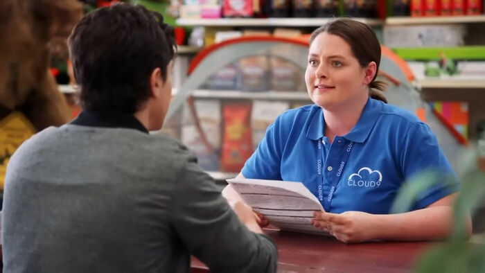 Two people in a casual discussion at a counter, highlighting the best Netflix shows that keep viewers coming back for more.