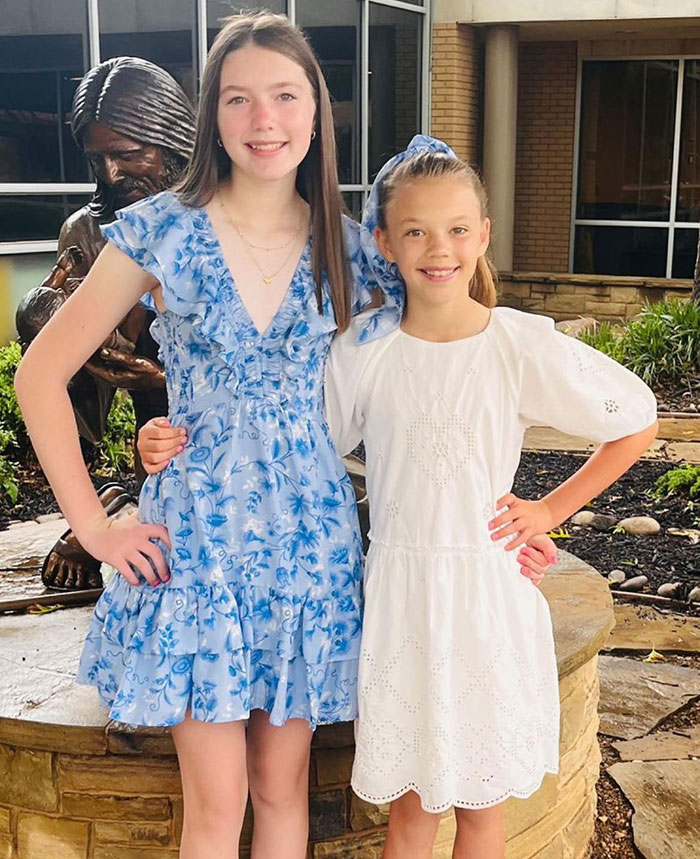 Two sisters standing together outdoors, remembered as Texas floods victims found with their hands locked together. Two sisters standing together outdoors, remembered as Texas floods victims found with their hands locked together.