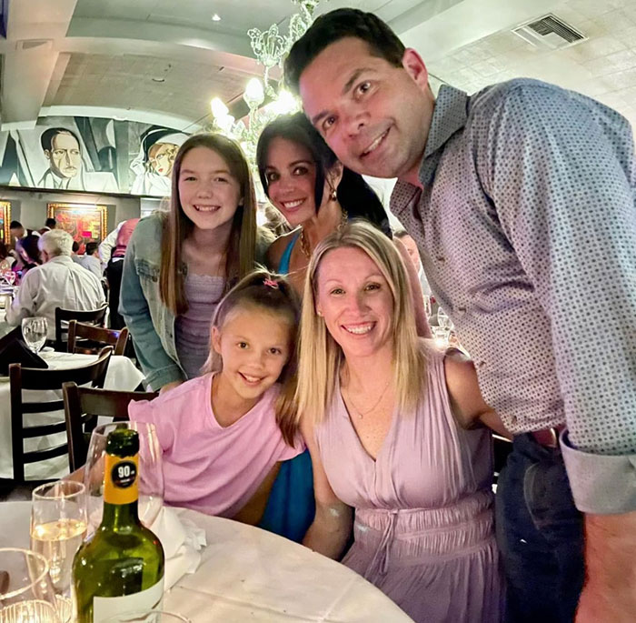 Family smiling together at a restaurant, representing sisters who lost their lives in Texas floods found holding hands. Family smiling together at a restaurant, representing sisters who lost their lives in Texas floods found holding hands.