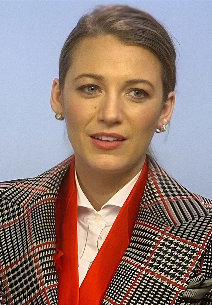 Blake Lively wearing patterned jacket and red scarf, reacting during court appearance after reality check from judge Blake Lively wearing patterned jacket and red scarf, reacting during court appearance after reality check from judge
