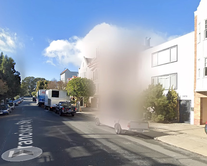 Neighborhood street with a house blurred on Google Maps showing why people are blurring their houses for privacy. Neighborhood street with a house blurred on Google Maps showing why people are blurring their houses for privacy.
