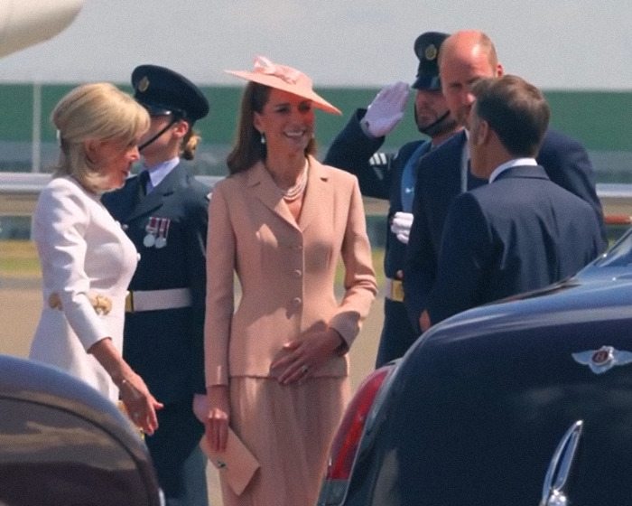 Brigitte Macron wearing white dress beside husband Emmanuel Macron during UK visit amid cold behavior claims. Brigitte Macron wearing white dress beside husband Emmanuel Macron during UK visit amid cold behavior claims.