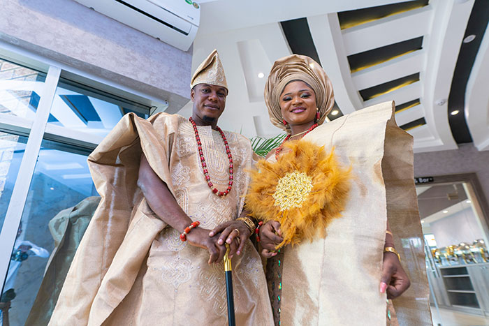 Bride and groom dressed in traditional attire, posing indoors with a bright smile, representing bride sister steal money caught camera. Bride and groom dressed in traditional attire, posing indoors with a bright smile, representing bride sister steal money caught camera.