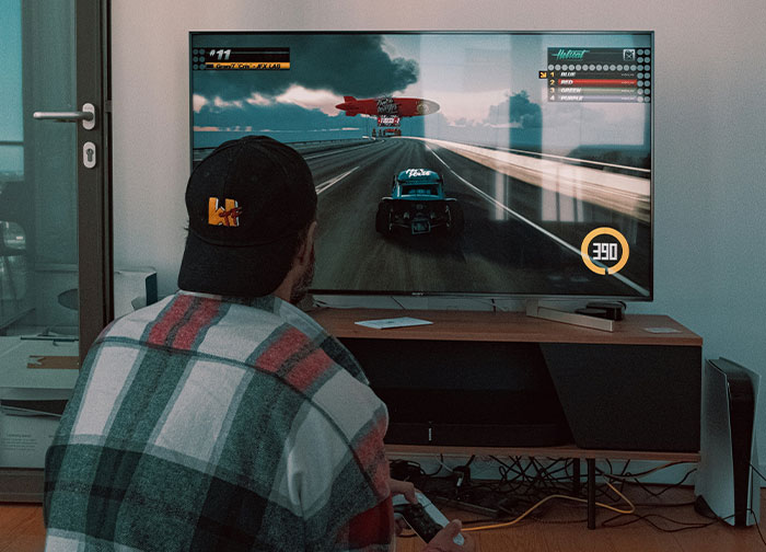 Man playing video games indoors, illustrating men get brutally honest and share what they never tell women feelings.