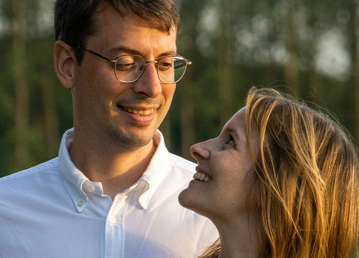 Couple outdoors with the man getting brutally honest and sharing thoughts men never tell women about appearance and feelings.