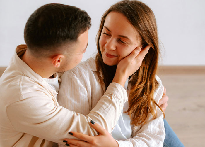 A man gently holding a woman’s face, sharing an intimate moment reflecting honesty between them.