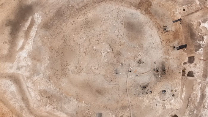 Aerial view of workers uncovering a 5000-year-old fortress during excavation for a solar farm construction site. Aerial view of workers uncovering a 5000-year-old fortress during excavation for a solar farm construction site.