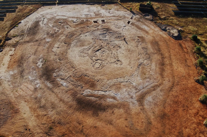 Aerial view of workers uncovering a 5000-year-old fortress during solar farm construction excavation site. Aerial view of workers uncovering a 5000-year-old fortress during solar farm construction excavation site.