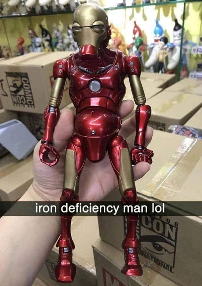 Hand holding an awkward Iron Man figure with a distorted body, a humorous example of awkward photos.
