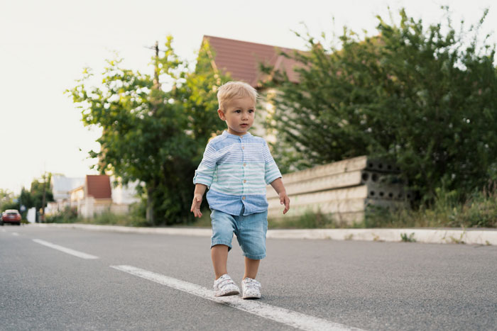 Toddler boy walking alone on a quiet street while neighbor has meltdown after calling cops on 2YO wandering the streets. Toddler boy walking alone on a quiet street while neighbor has meltdown after calling cops on 2YO wandering the streets.