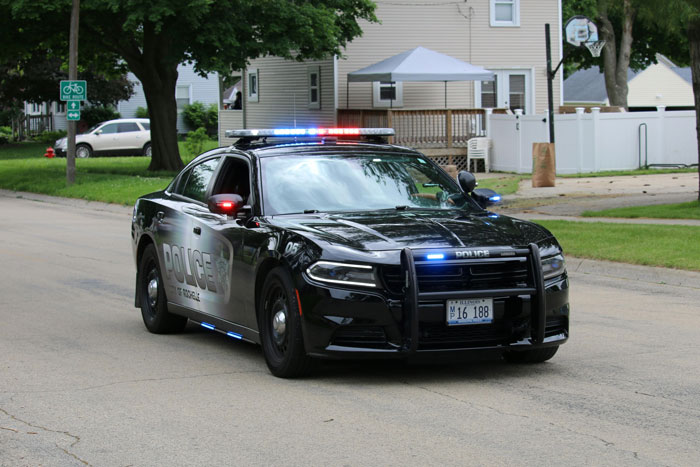 Police car with flashing lights on a residential street after guy’s neighbor called cops on 2YO wandering alone. Police car with flashing lights on a residential street after guy’s neighbor called cops on 2YO wandering alone.